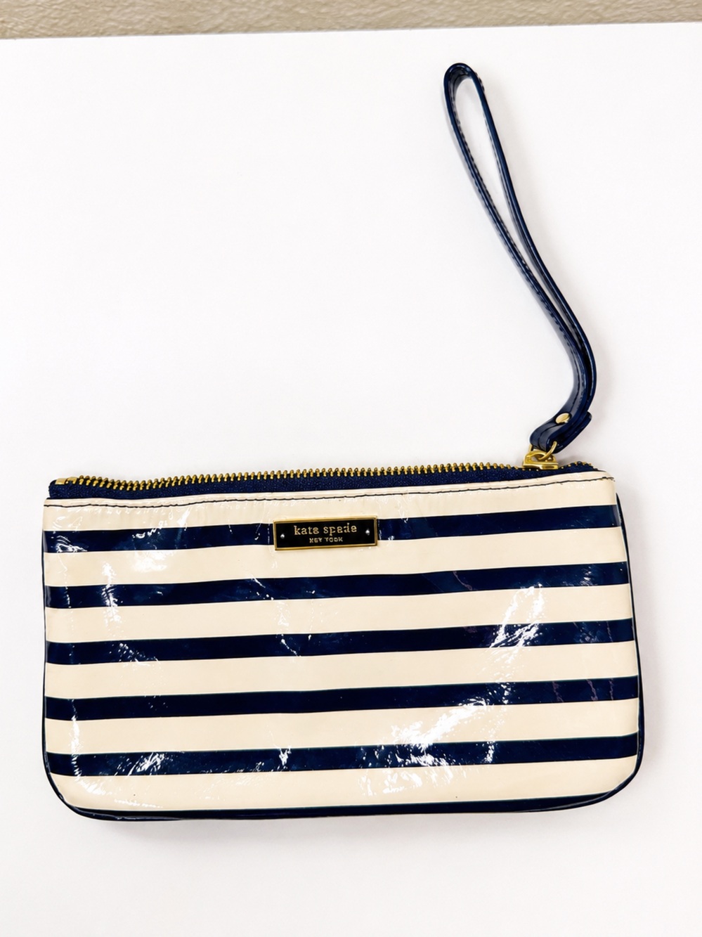 kate spade navy and cream striped patent wristlet with gold accents